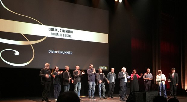Didier Brunner onstage at the closing ceremony with animators he has worked with