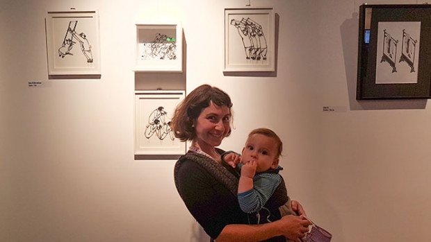 Dina Velikovskaya, holding her son, with panels from her film Ties