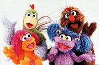 Dafi (purple), Oofnik (brown), Haneen (orange), and Kareem (rooster) in the Israeli/Palestinian co-production Rechov Sumsum/Shara'a Sumsum. © CTW. Sesame Street Muppets © Henson.