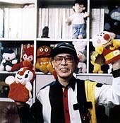 Mr. Yanase at the Museum surrounded by his beloved and financially-rewarding pals. © Yanase Studio, 1999.