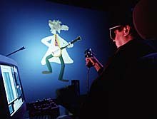 An animator uses the SANDDE wand while reviewing the real-time results on a projection system that simulates the IMAX 3D theater experience. © 1997 Imax Corporation SANDDE Animation.