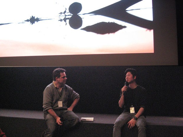 Olivier Catherine interviewing Erick Oh under image from one of Erick’s film.