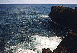 The rocky cliff shore of Cap Méchant or Mean Cape.