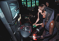 During a press conference in New York August 19, 1997, actresses Maud Adams, left, and Grace Jones, both of whom starred in James Bond films, play the Nintendo game Goldeneye 007. Photo courtesy of Newscom.com, Feature Photo Service.