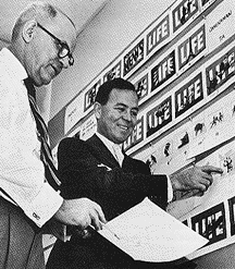 Messmer (left) discussed with Don Leigh a storyboard for a giant animated electric sign. Courtesy Doris Messmer.
