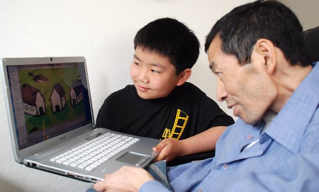 Perry showing his father some of his latest work on his tribute film, Changyou's Journey.