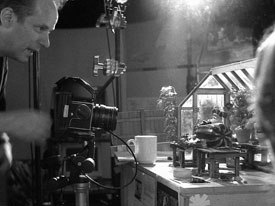 Writer, director and producer Nick Park works on a miniature set. DP Dave Alex Riddett lit the film for live-action realism creating a retro 50s feel.