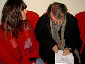 Peter Lord sits with his wife while he draws a picture of Wallace and Gromit for some lucky fan at I Castelli Animati. Courtesy of Barbara Robertson.