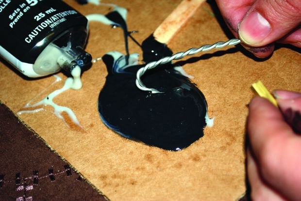 [Figure 3.9] Dipping wires into the epoxy glue.