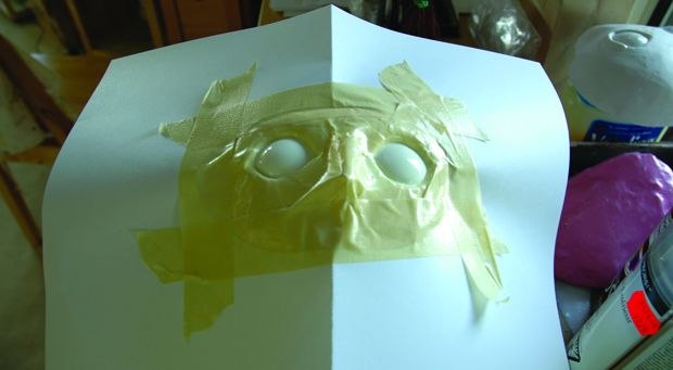 [Figure 3.49] Masking the head and exposing the eyes for coating.